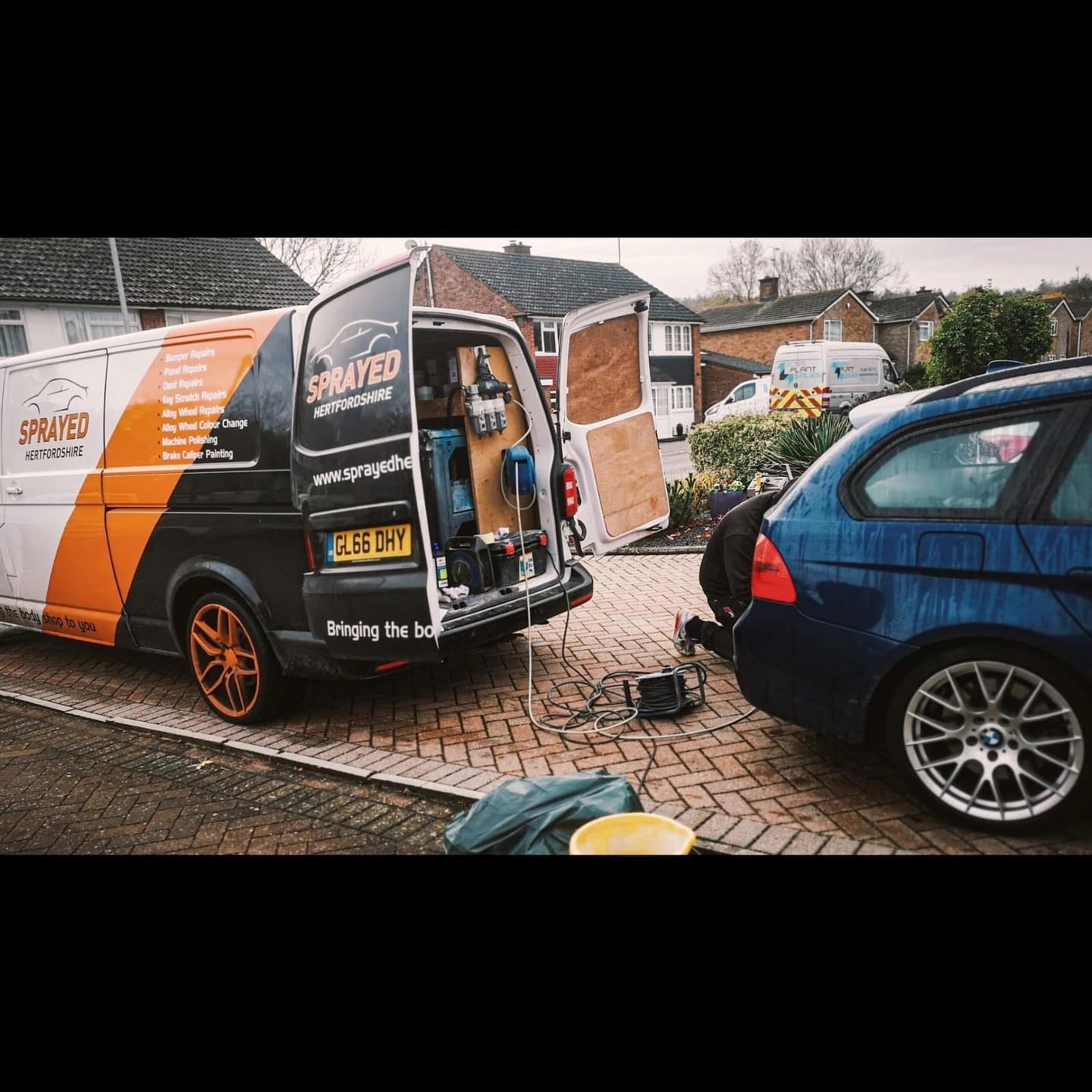 Blue BMW with Sprayed Hertfordshire service van on driveway