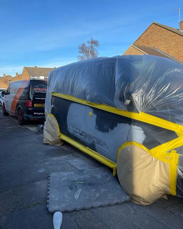 Car wrapped in protective plastic sheeting
